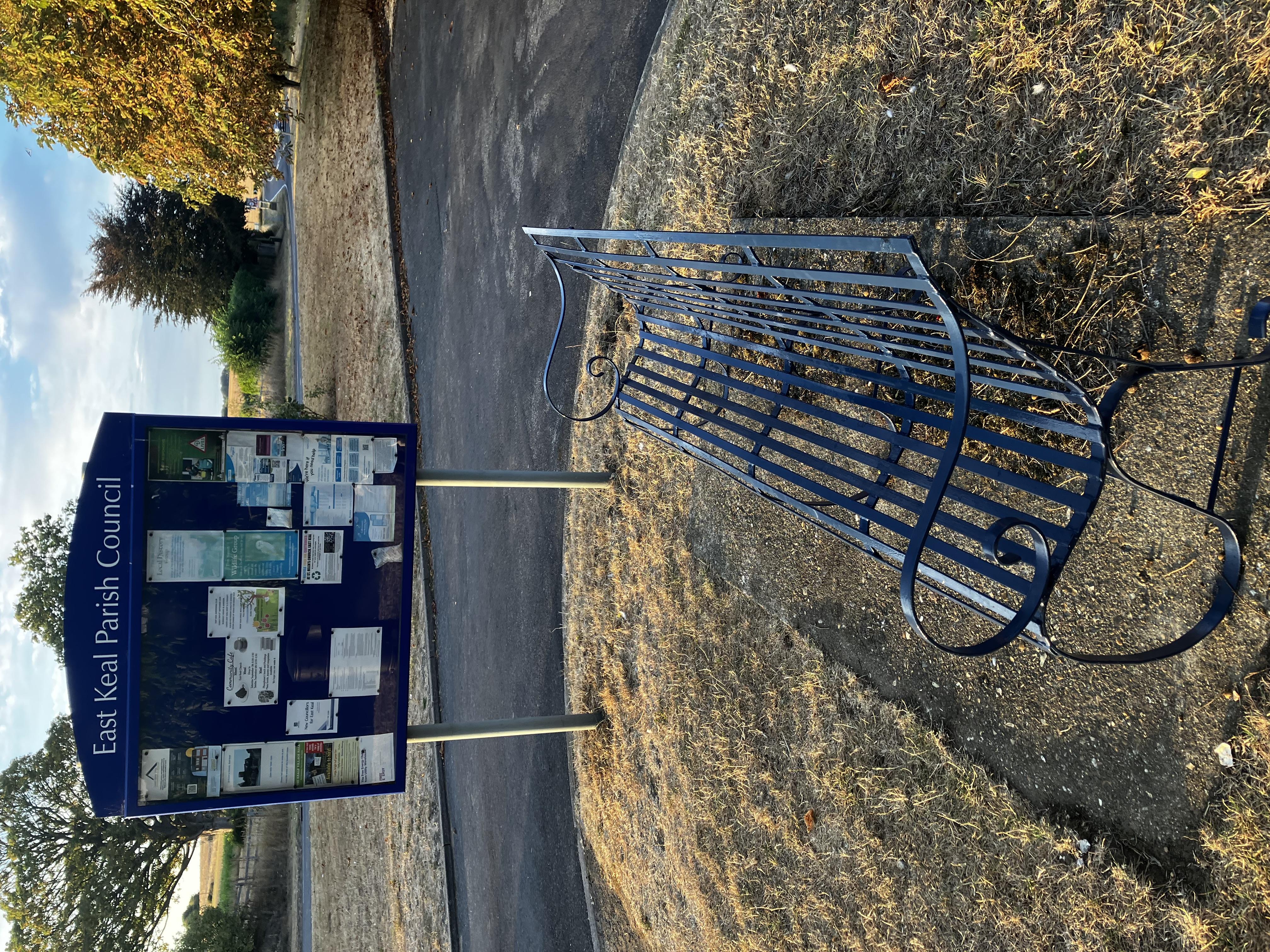 Bench and noticeboard on the green